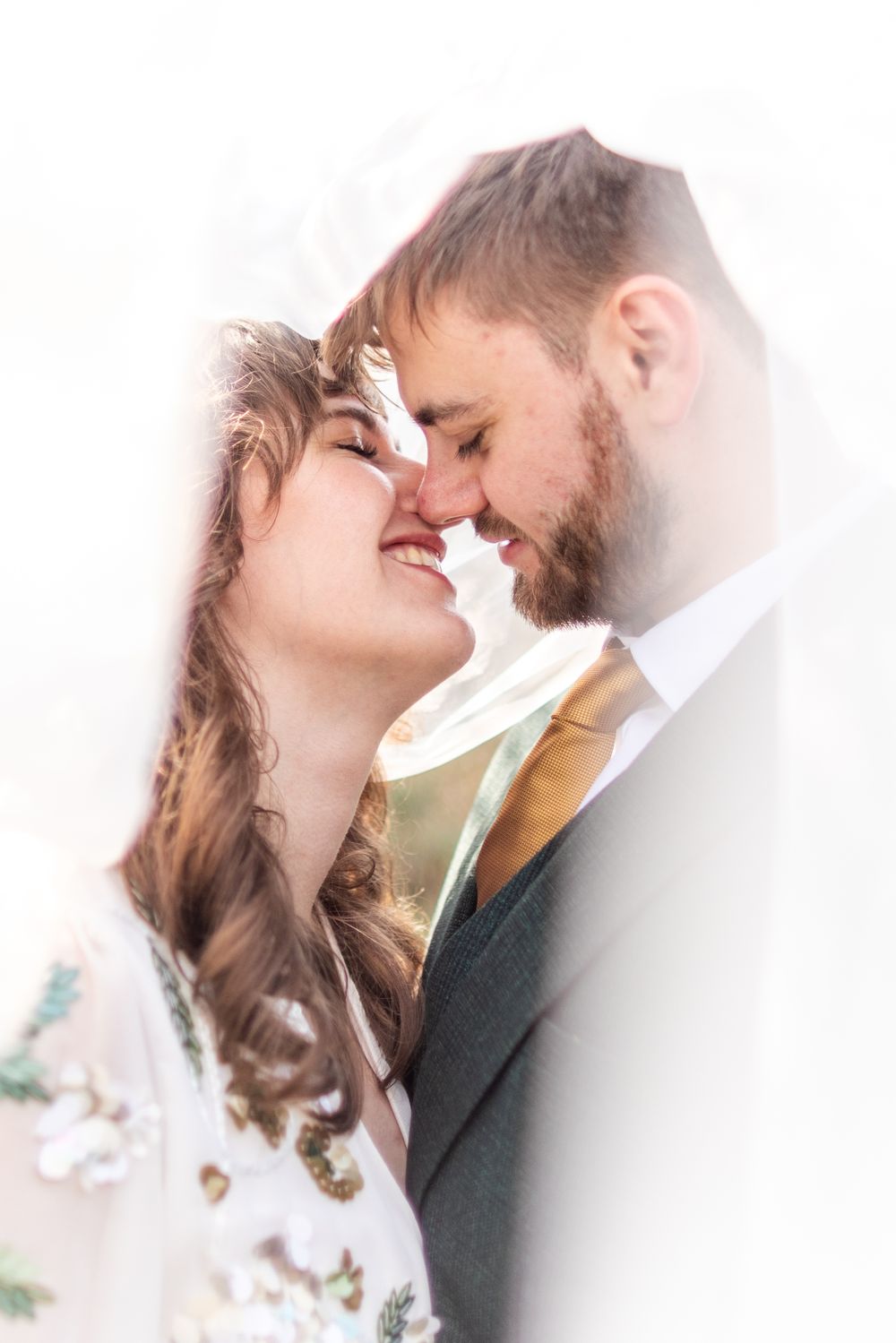 An intimate romantic moment captured in soft focus with a dreamy, ethereal quality.