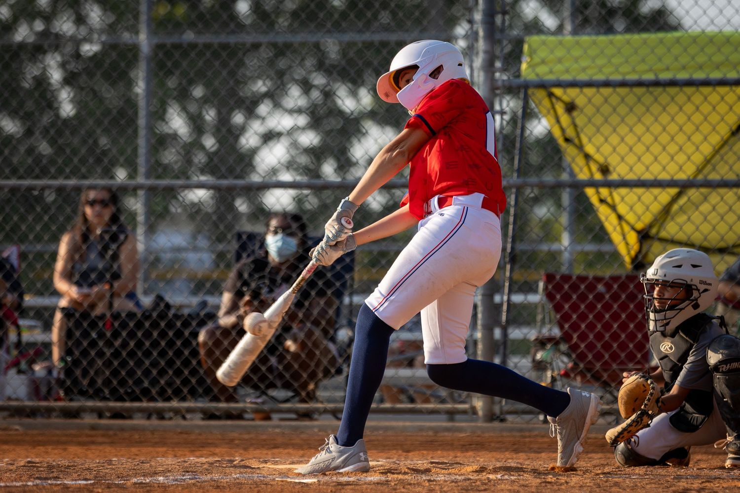 Drew Arnold Photography Youth Baseball hit with the bat touching the ball.