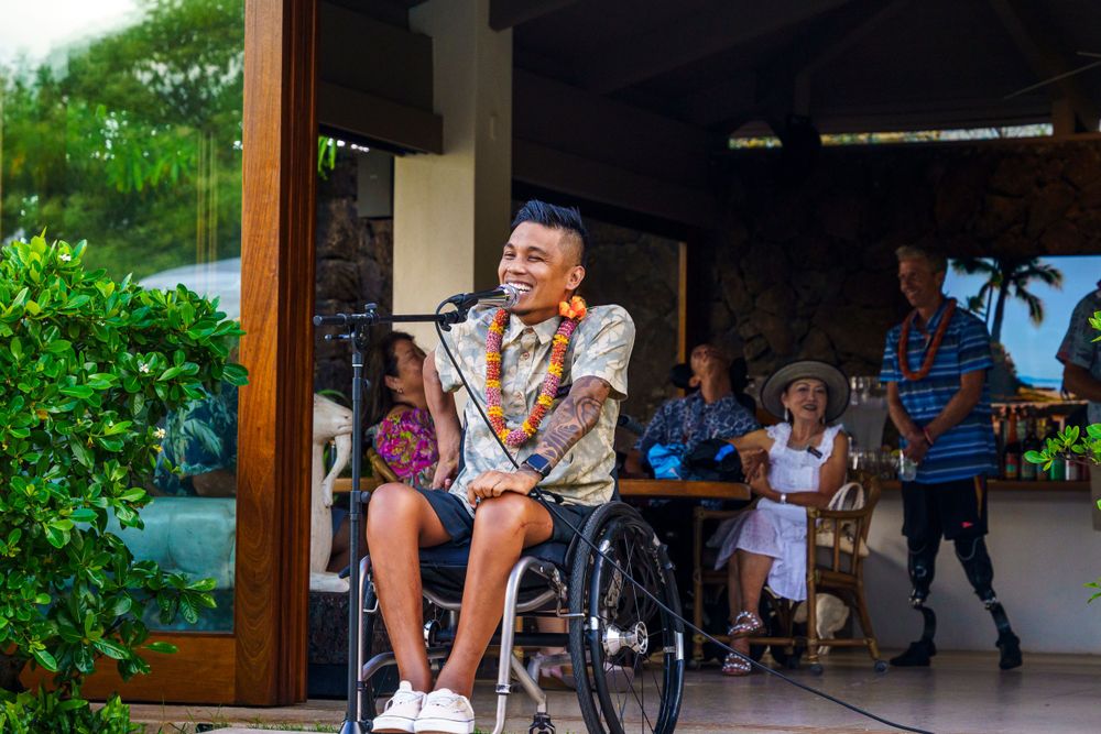 Covered outdoor patio area with guests gathered for a tropical celebration.