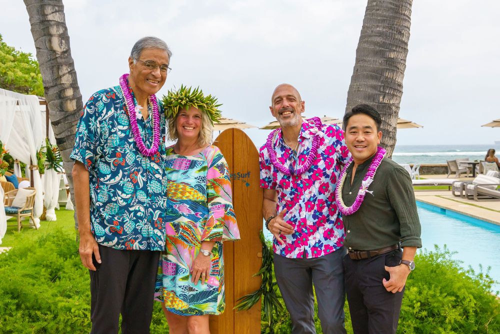 Beachside gathering with tropical flowers and palm trees in Hawaii.