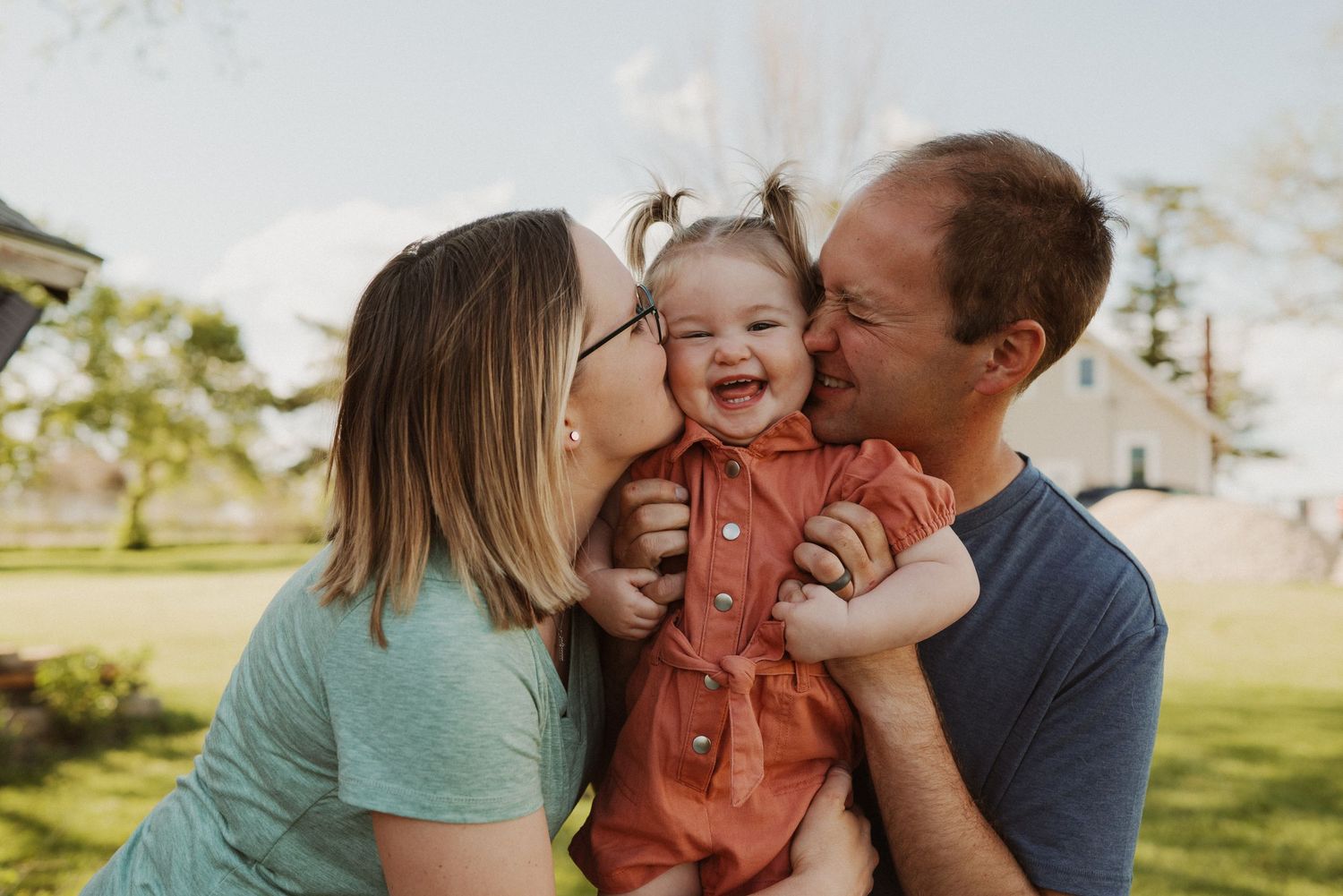 Family portrait at sunset with autumn foliage creating warm golden backdrop.