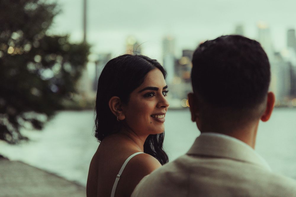 photo of Couple setting in front of the toronto islands
