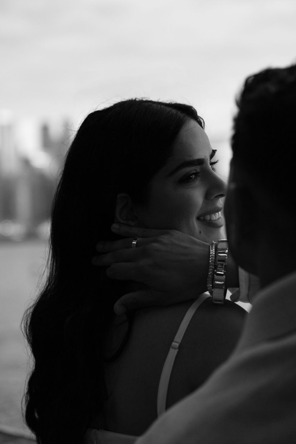 black and white photo of Couple sitting in front of the toronto islands