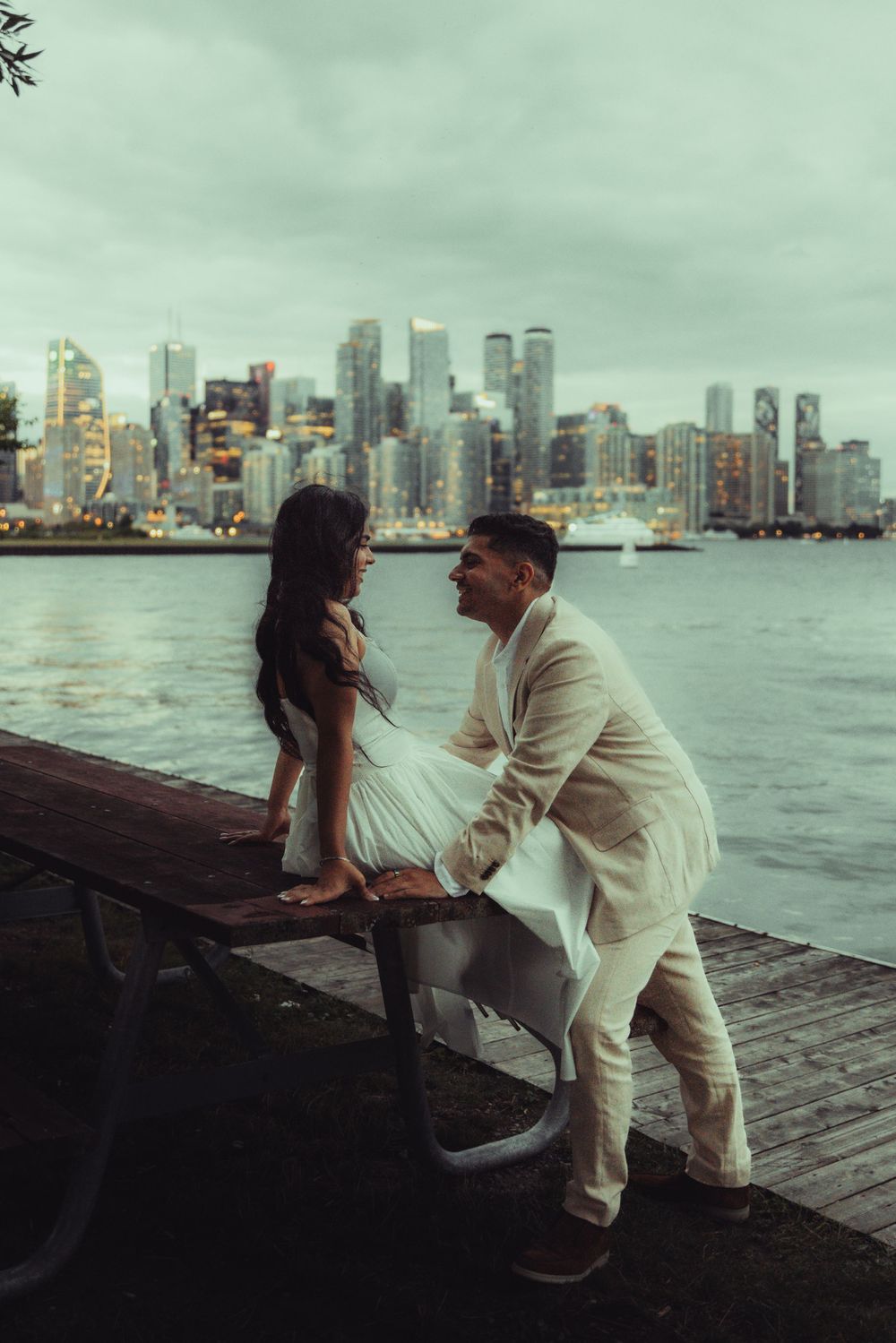 photo of Couple sitting in front of the toronto islands