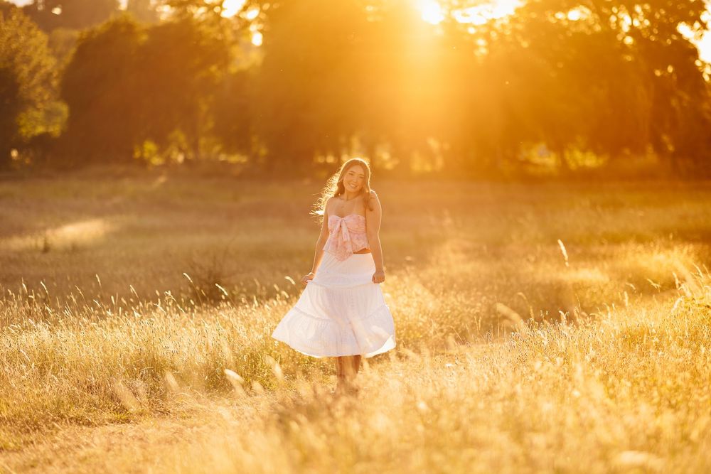 Golden hour light creates warm glow across field at sunset.