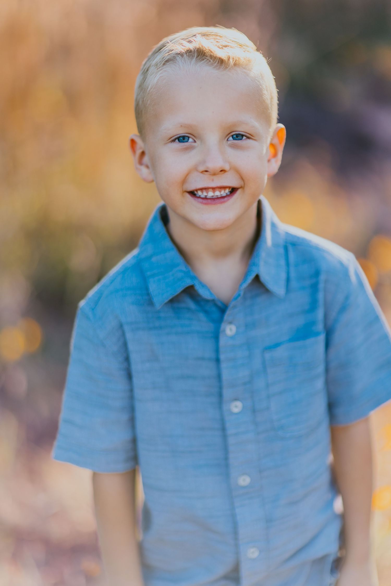 Series of joyful expressions wearing light blue polo shirt against warm sunset lighting.