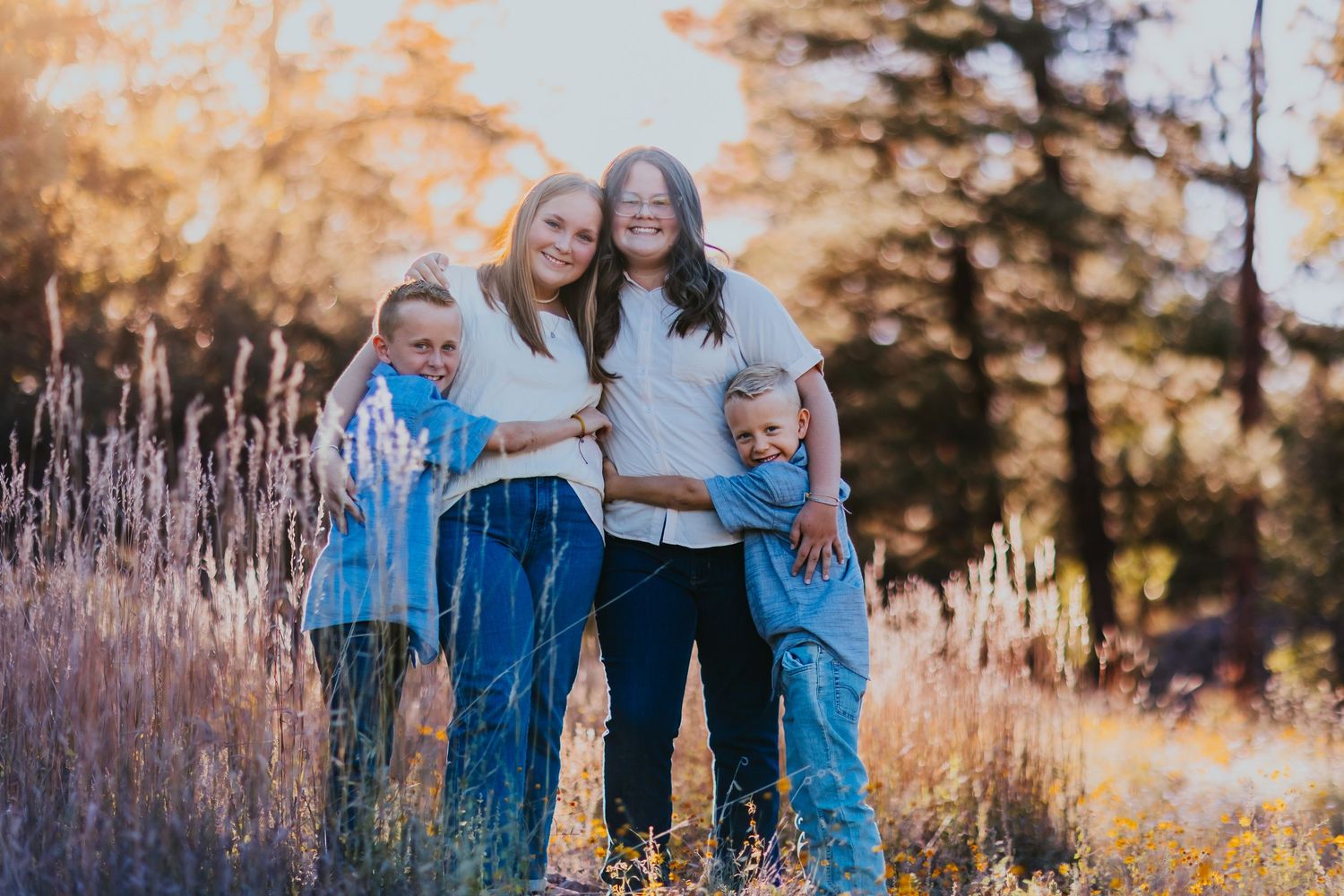 Family group photos in a field with tall grass during golden hour.