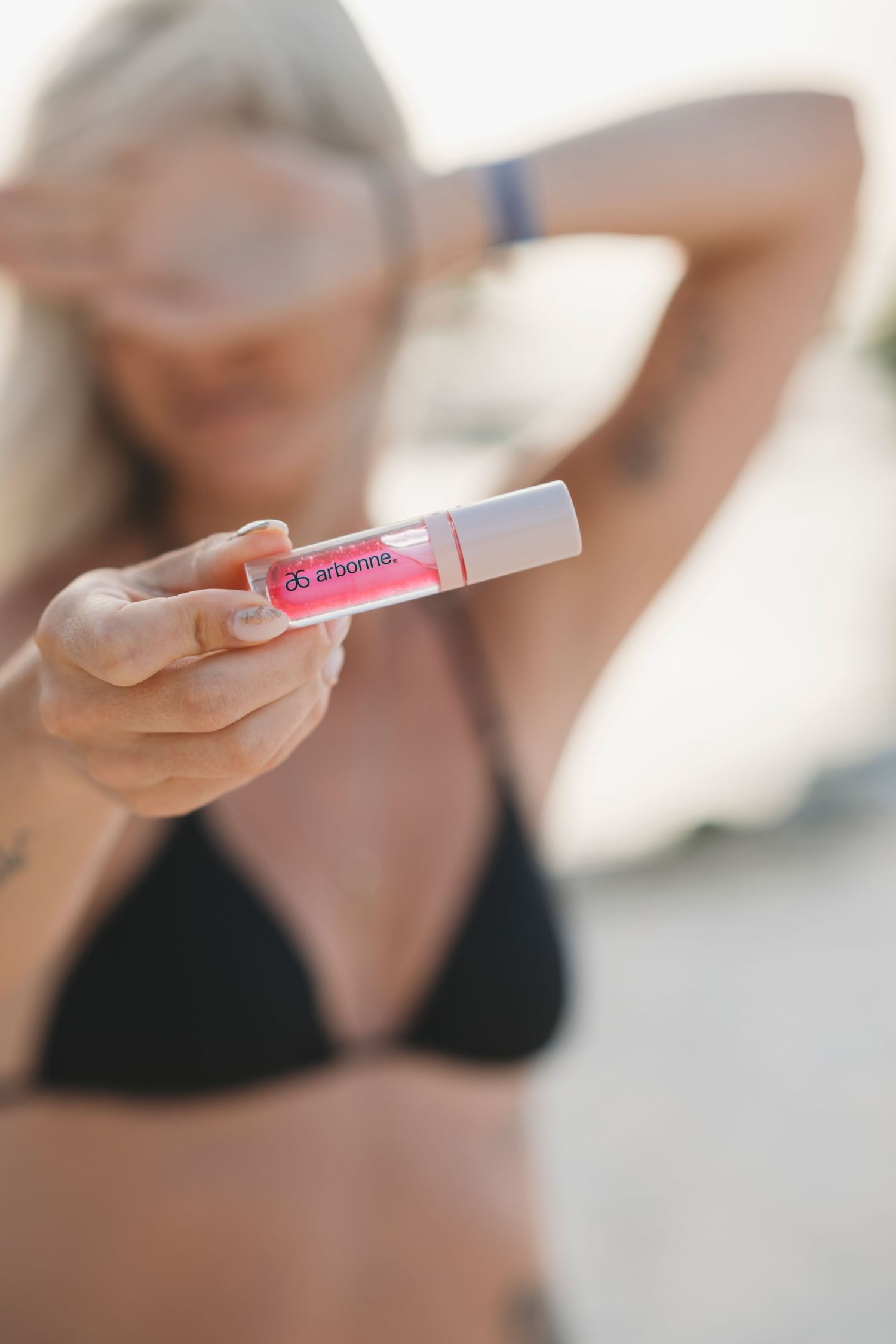 Close-up view of hands holding a pregnancy test showing positive results in a soft natural light setting.