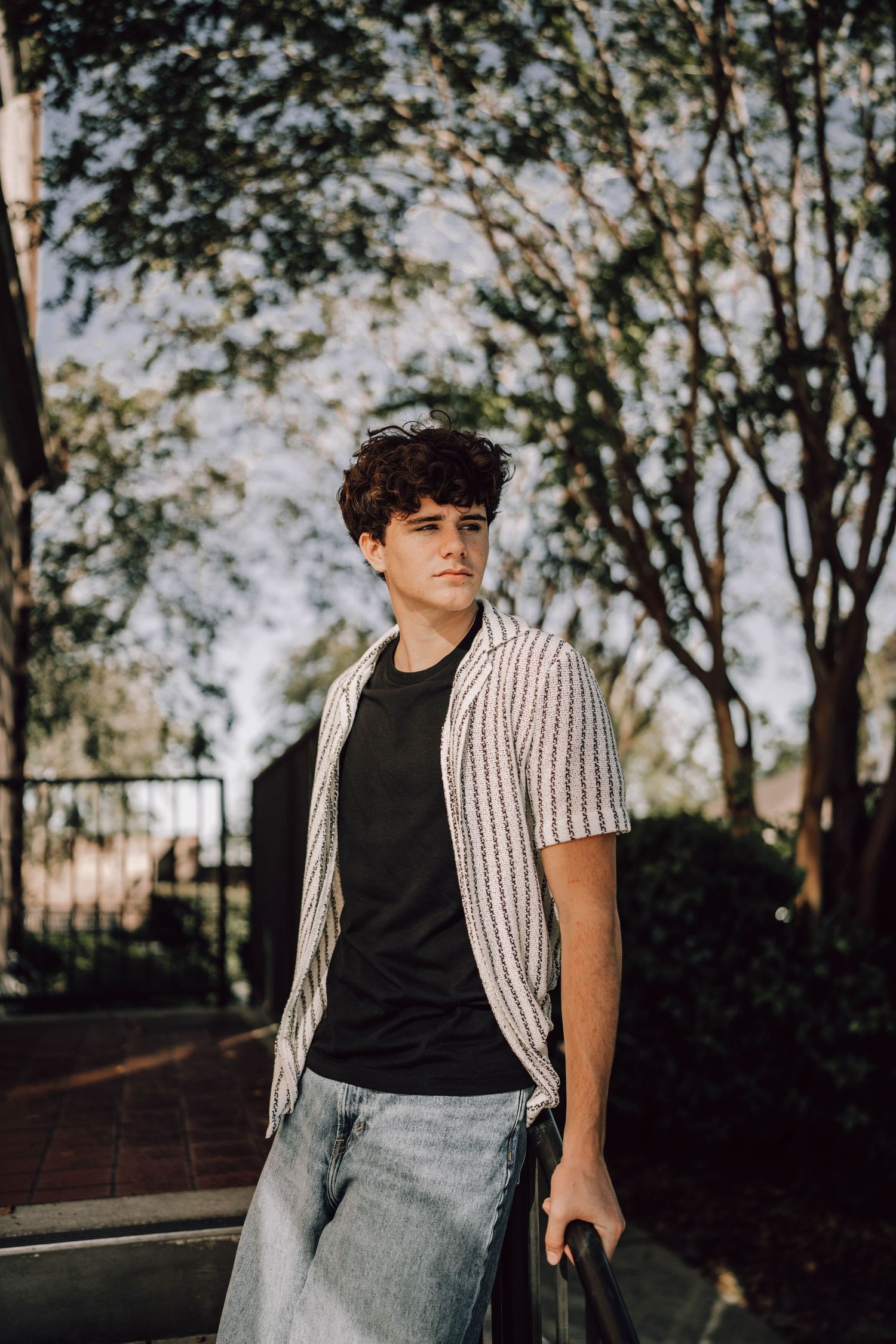 Artistic portrait series in tall golden grass during sunset with soft natural lighting.