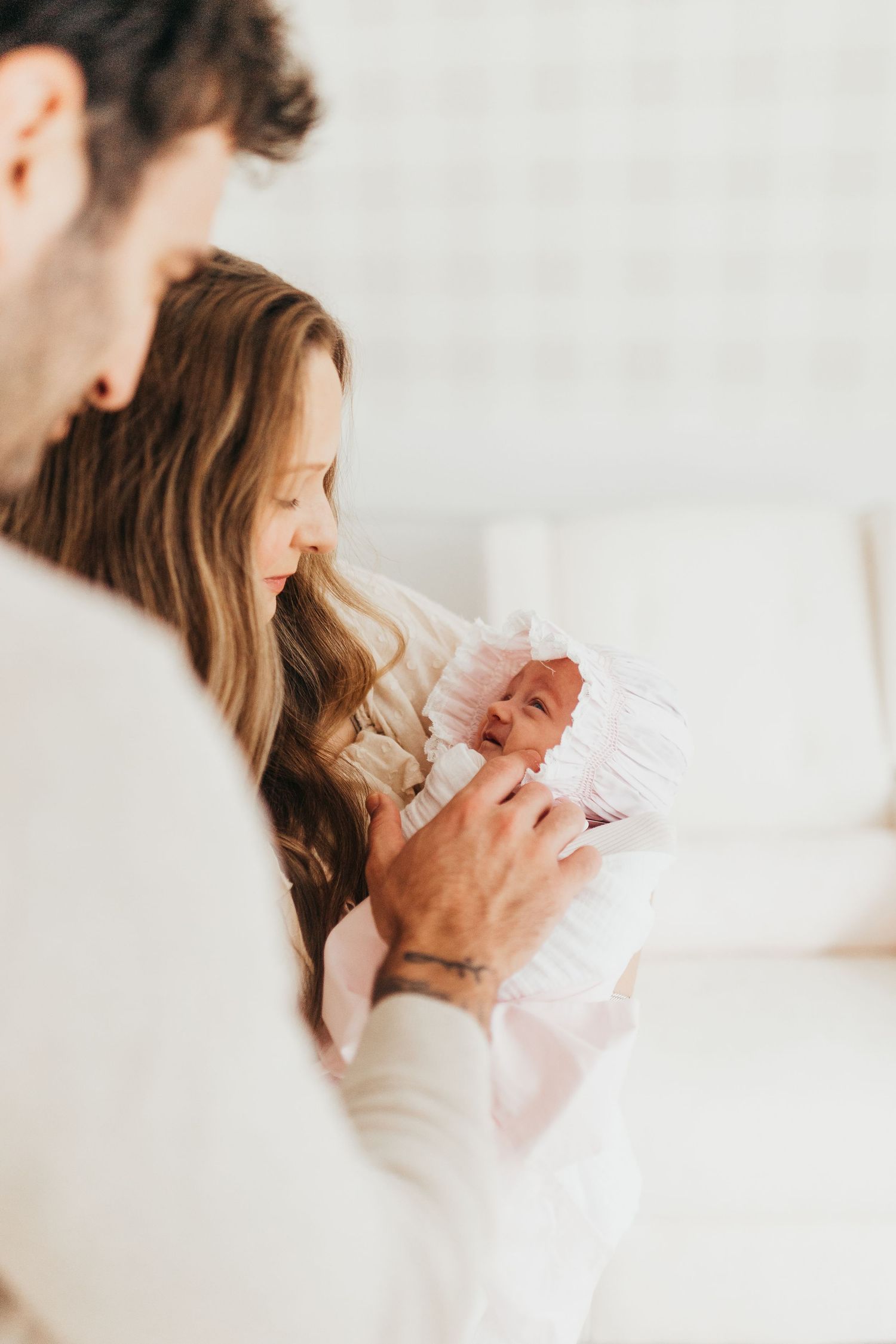 Tender family moment with toddler and baby in casual home setting.