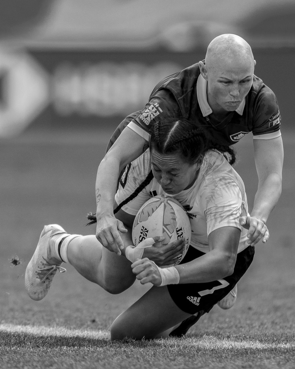 Canadian rugby player makes a big tackle mid-field against Ferns Rugby player at Rugby Sevens event in LA. Sports. Rugby.
