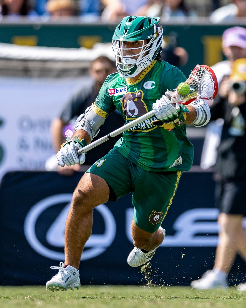 Lacrosse player craddles the ball up the field in a match. California Redwoods. Premier Lacrosse League Sports photography