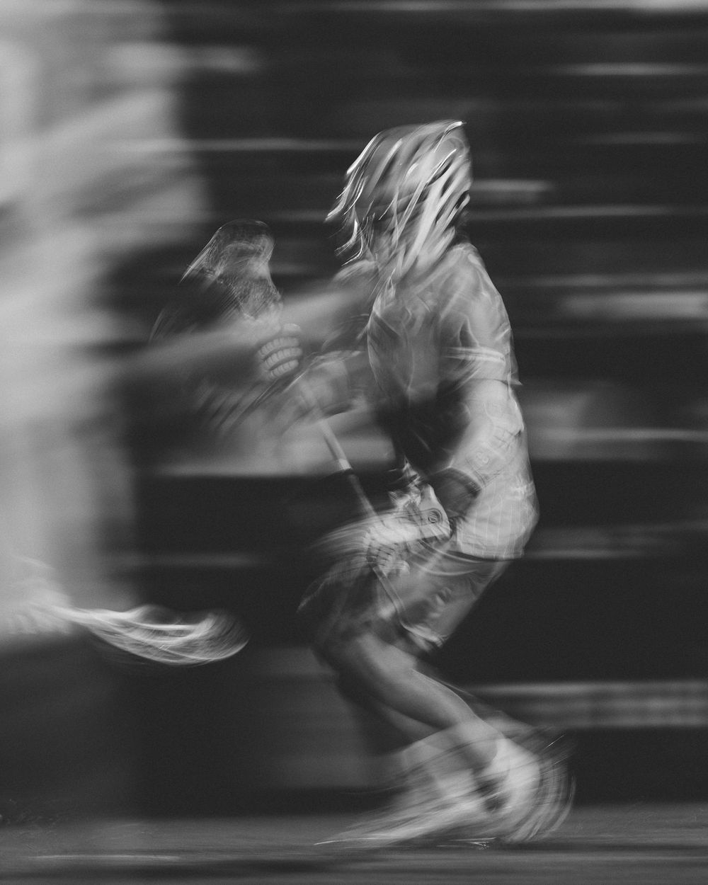 A lacrosse player cradles the ball in a slow shutter speed, artistic photo. Premier Lacrosse League. Sports Photography