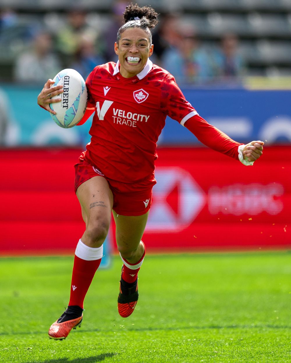 Canadian rugby sevens athlete celebrates as she is about to score a try during match in Los Angeles. Sports Photography