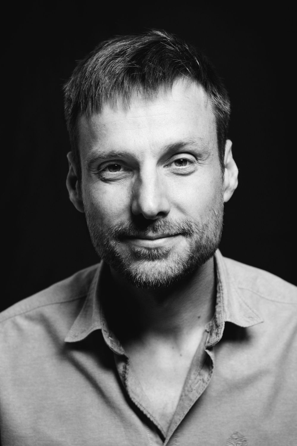 Black and white portrait series showing different expressions.