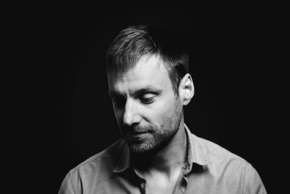 Dramatic black and white headshot series in low key lighting.