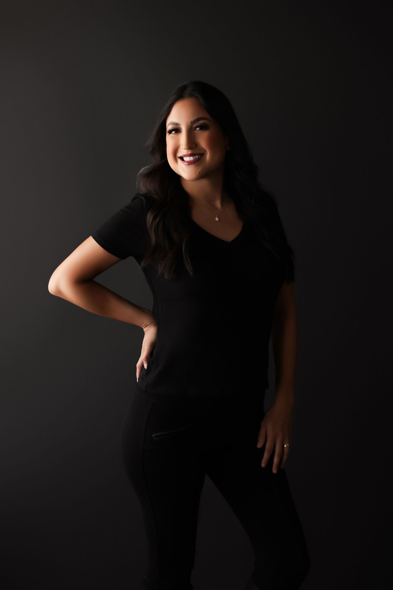 Natalie Noir Studio photographer smiling happily dressed in black