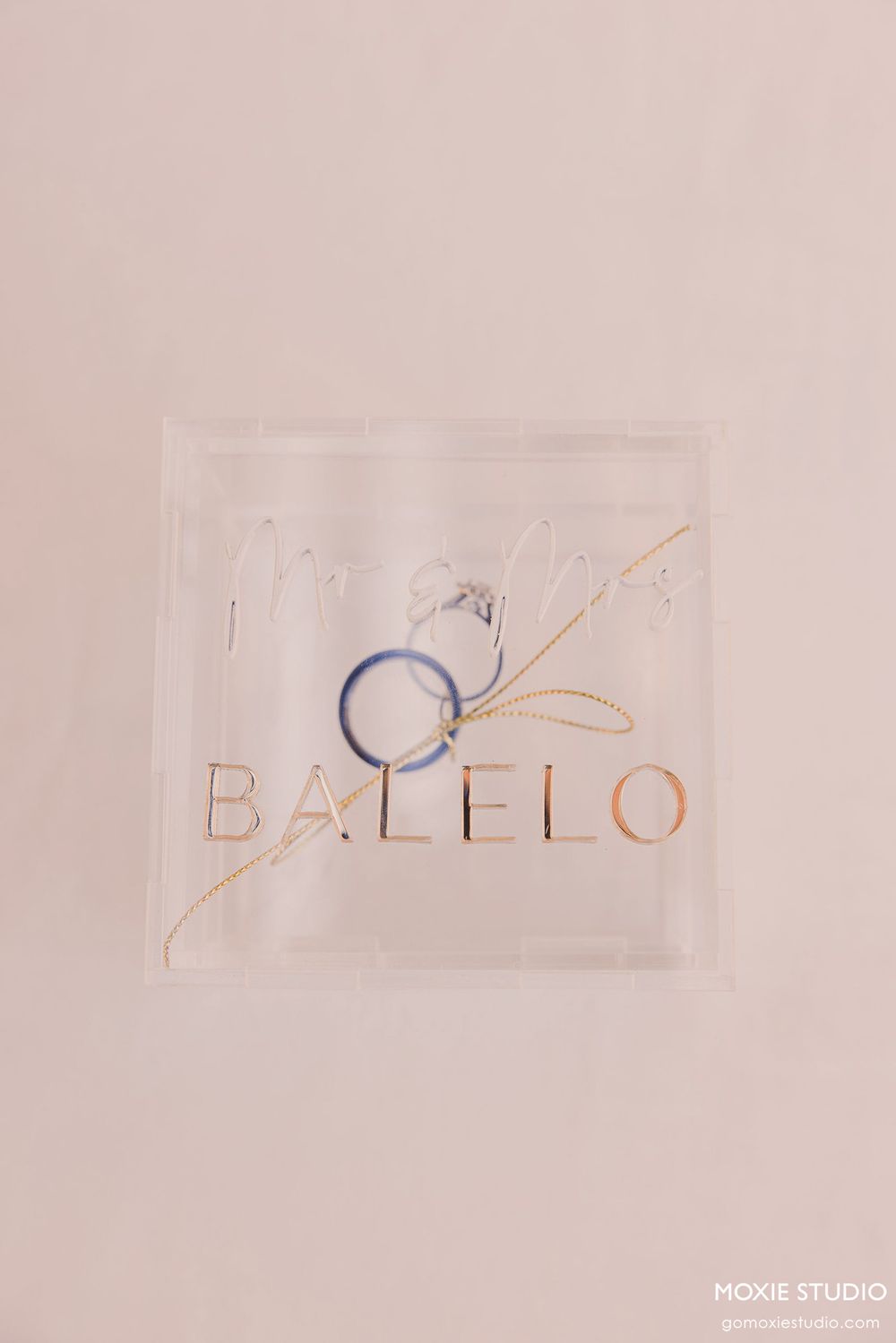 Minimalist logo design process showing sketched letters and shapes on light beige background.