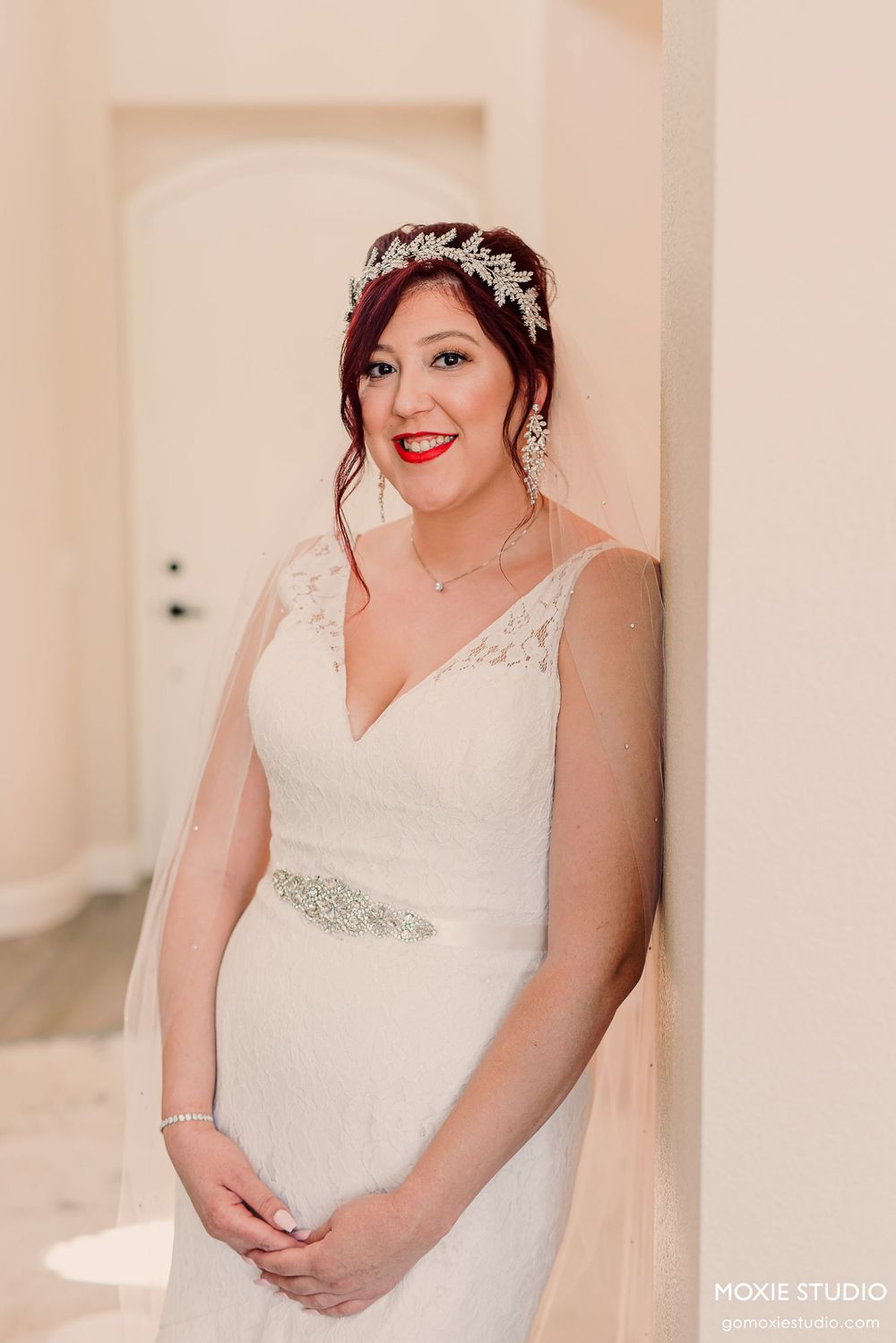 Elegant bridal portraits showing details of a white lace wedding dress and crystal headpiece.
