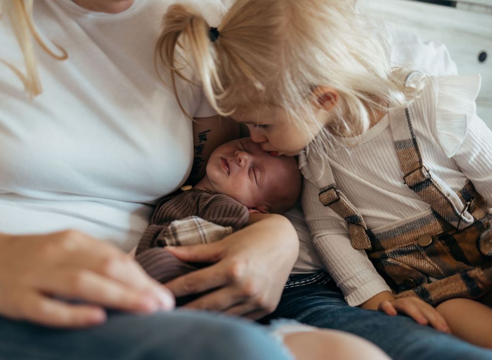 A tender moment shared between parent and child on a couch.