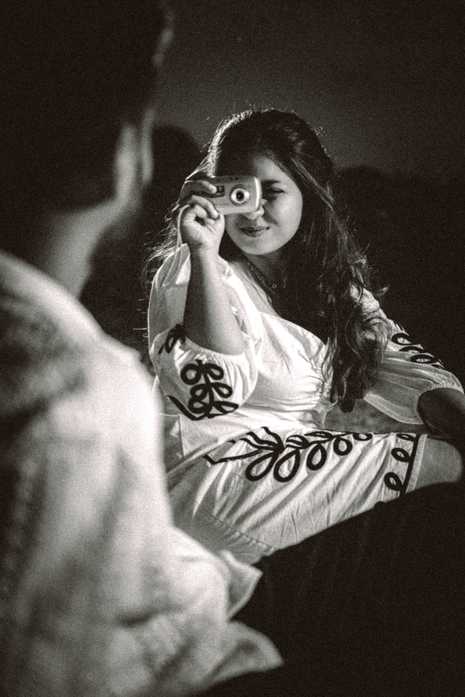 Artistic black and white portrait showing someone looking through a decorative lens.