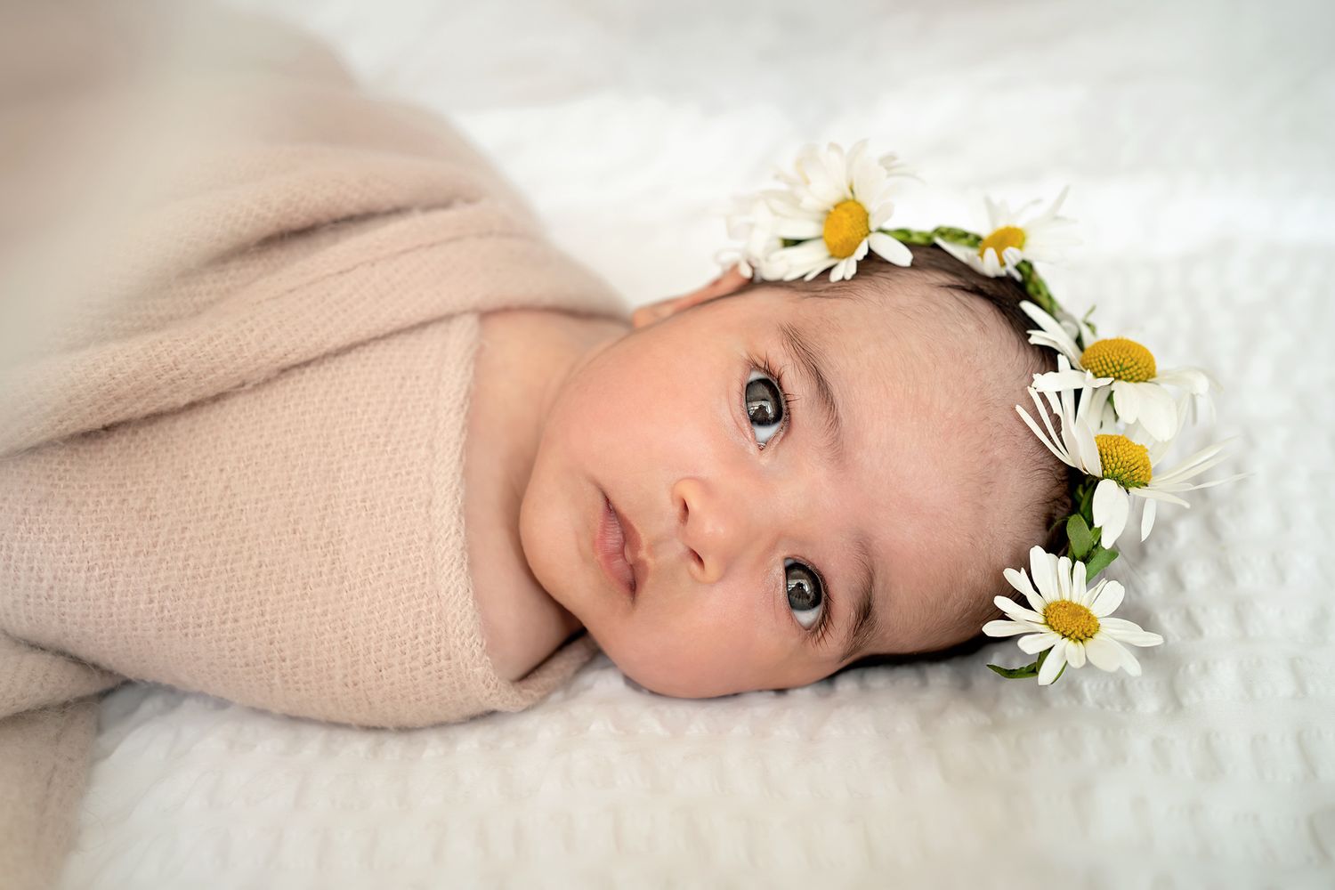 A baby posing with daisies flowers crown in Southampton, Hampshire, UK.