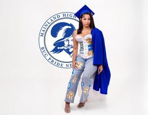 A person wearing distressed denim jeans and a blue jacket poses against a white background with a logo visible.