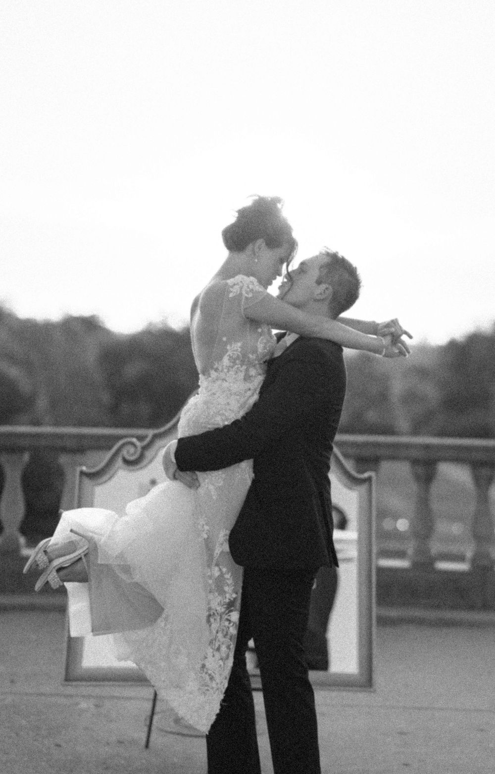 Black and white photo sequence of a romantic dance dip between newlyweds at an outdoor wedding celebration.