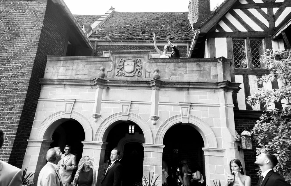 Black and white photographs of a wedding ceremony arranged in a filmstrip-style collage showing venue and ceremony details.