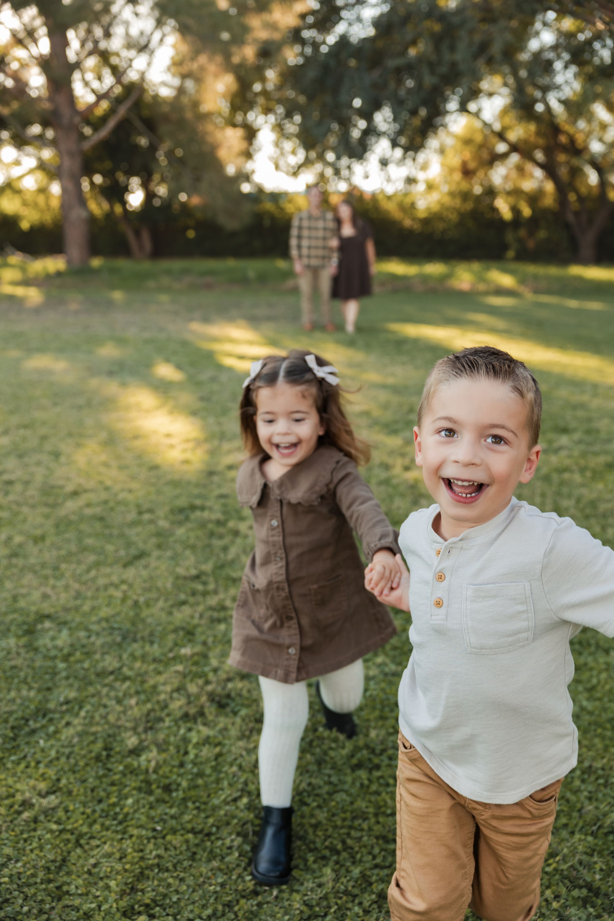 Three candid shots of children playing and running joyfully on a grassy hill during golden hour.