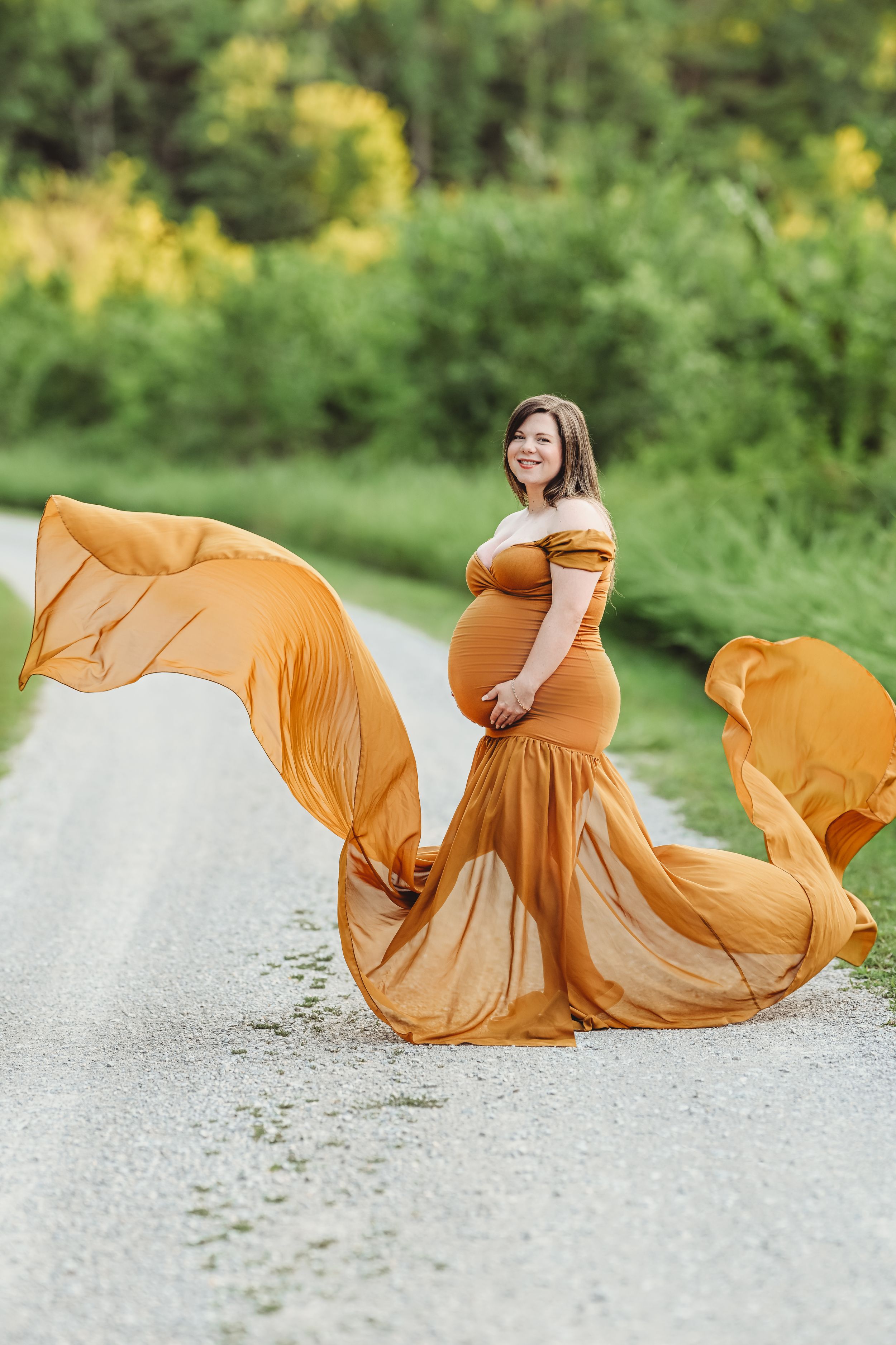 Flowing mustard yellow dress movement captured in sequence on a gravel path.