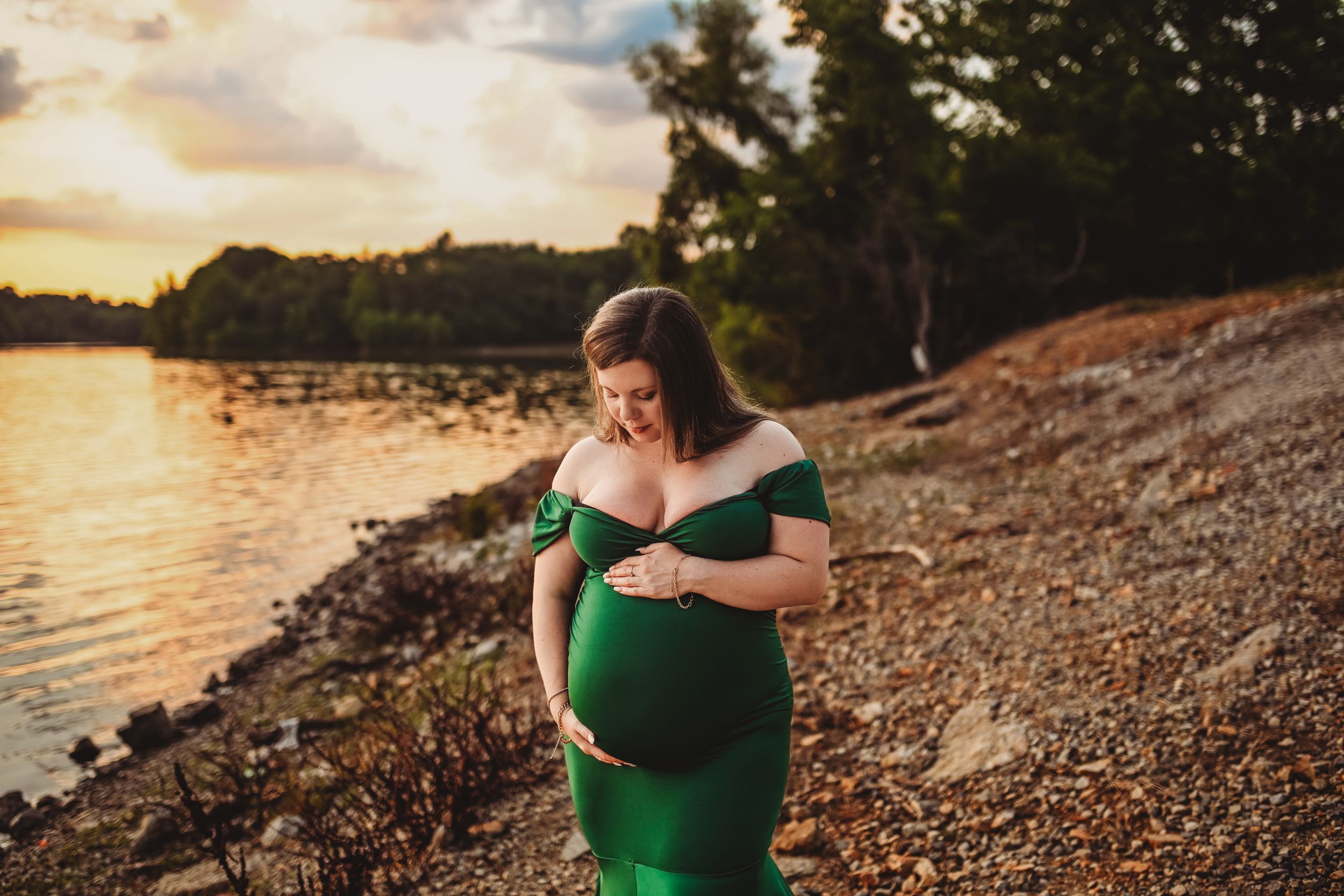 Emerald green dress silhouette against a sunset beach backdrop.