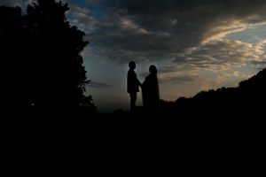 Dramatic sunset silhouettes against a cloudy sky.