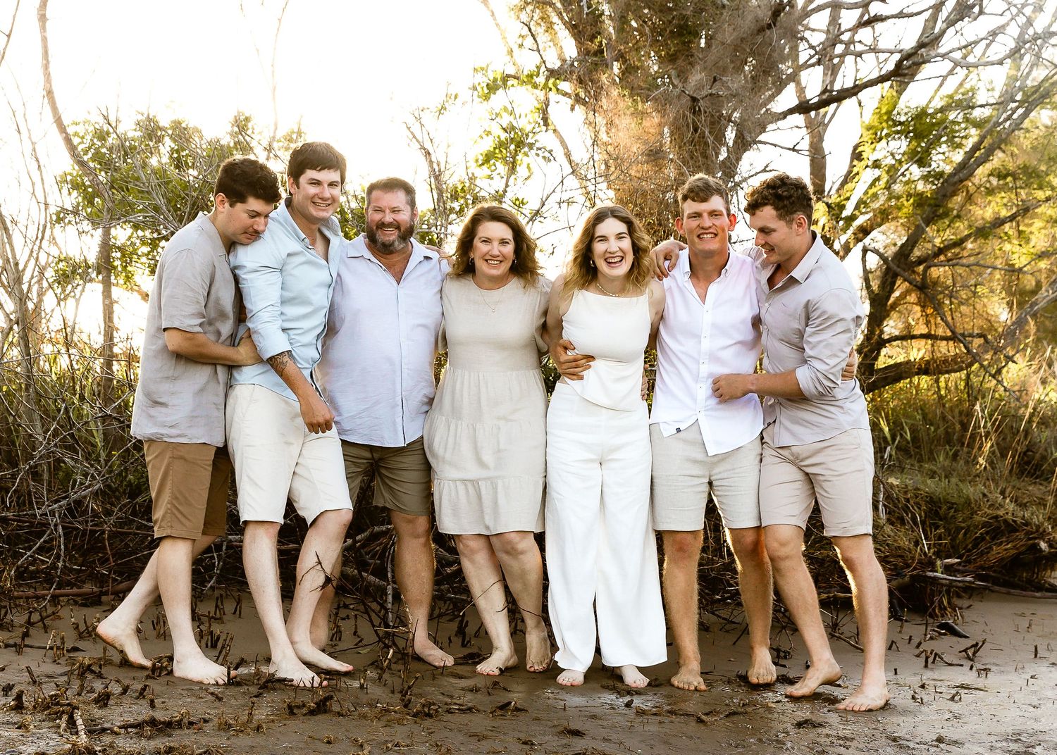 Siblings cuddling during a family portrait shoot at a natural Brisbane outdoor location