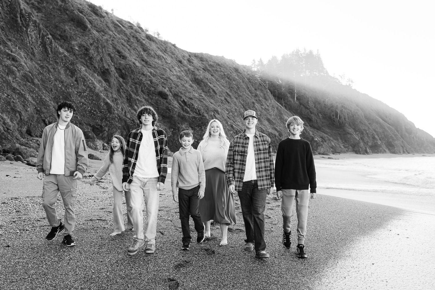 Black and white image of family walking along the beach outside of Gold Beach, Oregon