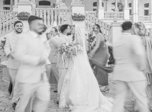 A series of black and white wedding photos showing dancing and celebration at an outdoor reception.