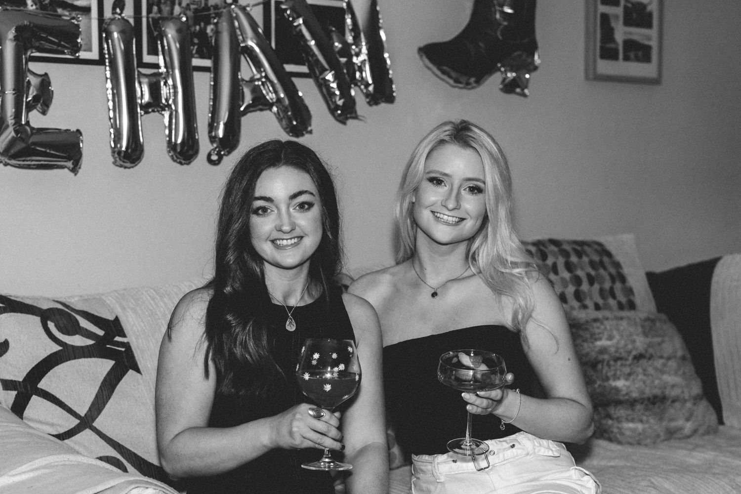 Group of friends enjoying wine and conversation at a casual gathering in a home setting.