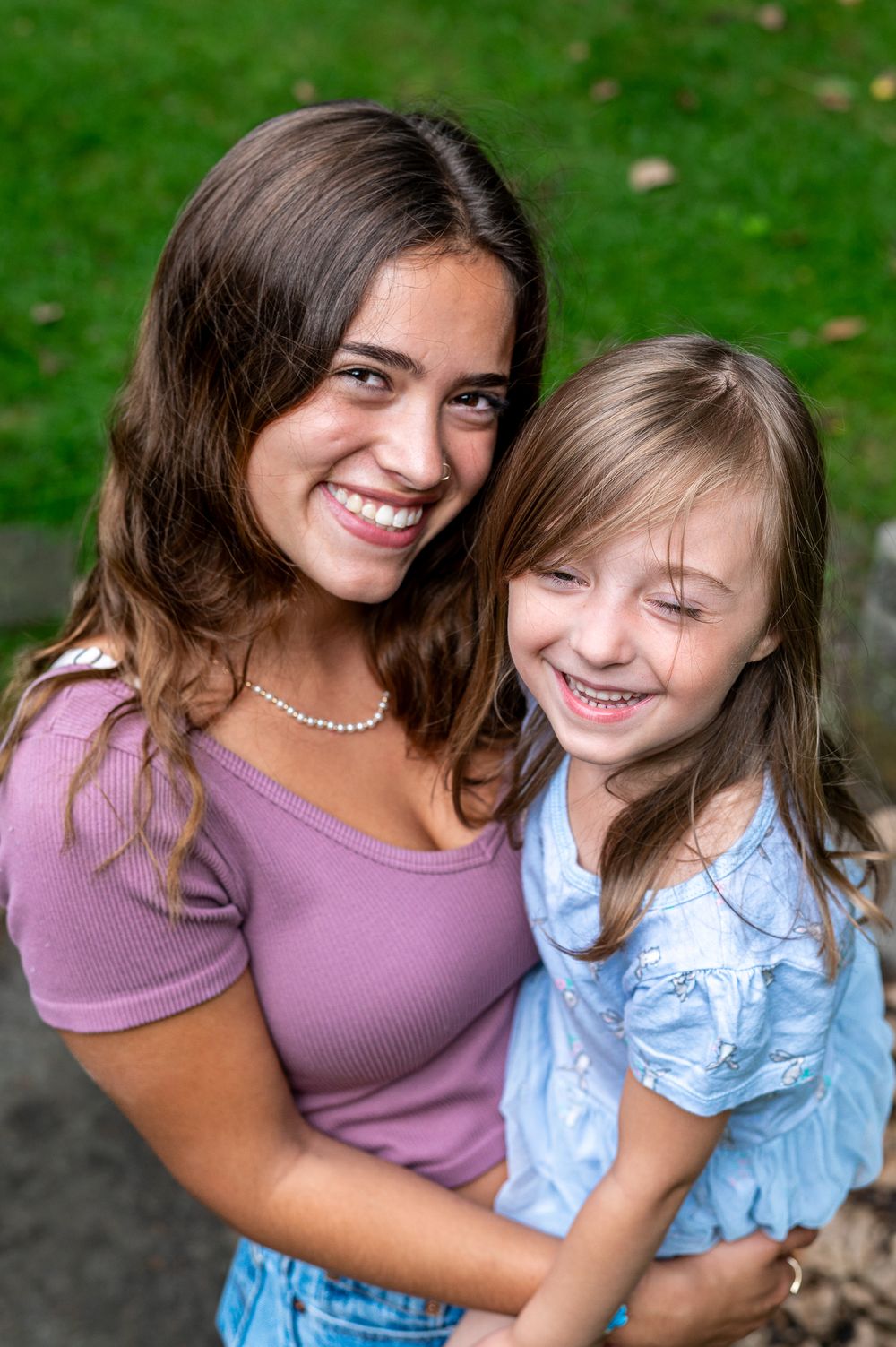 Portrait of two people sharing a joyful moment outdoors.
