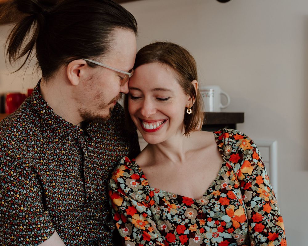 Candid couples photoshoot. Couple cuddling together in an intimate and comfortable environment.