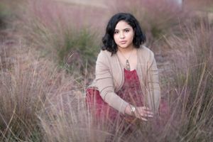 Autumn portrait series in field of pink grass with natural lighting.