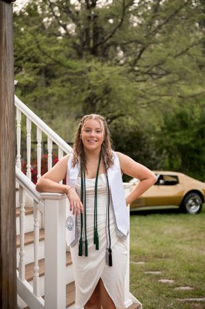 White stairs and railing create an elegant backdrop for an outdoor photoshoot.