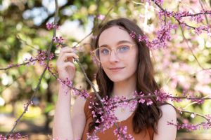 A springtime portrait with delicate pink cherry blossoms framing the scene.