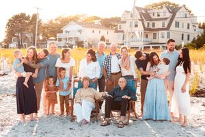 A family of three generations posing for a family portrait on Goose Rocks Beach in Kennebunkport, ME