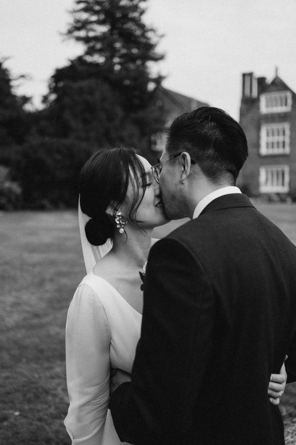 Cotswolds wedding couple kissing captured in documentary style with an editorial touch