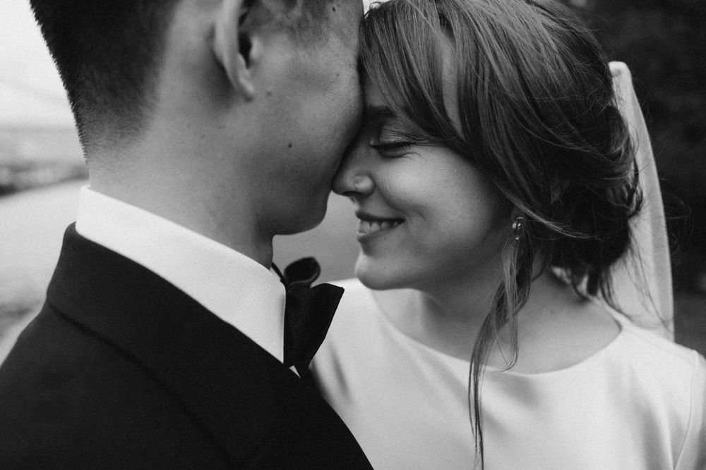 Bride and groom couple potrits outside Chelsea Old Town Hall, London wedding venue, captured in a documentary editorial way