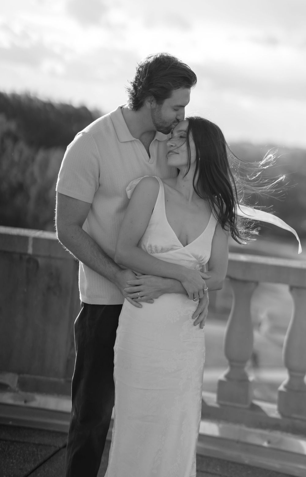 Black and white romantic couple portrait series showing intimate embraces and tender moments outdoors.