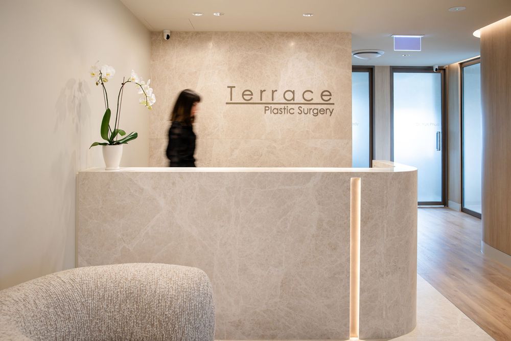 Modern minimalist hallway with white walls, recessed lighting, and hardwood flooring creates a bright, clean aesthetic.