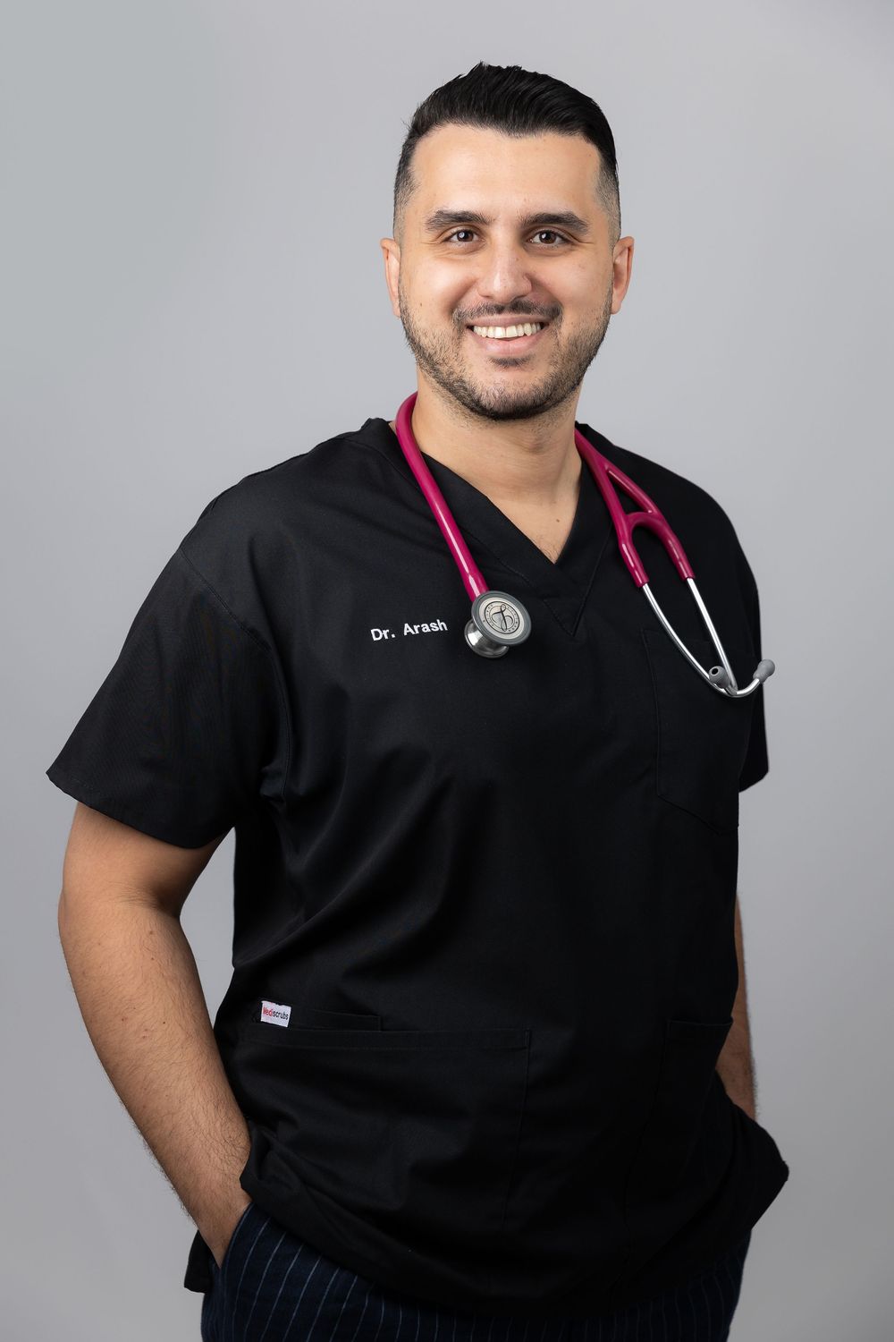 Medical professional in black scrubs and stethoscope shown in multiple professional headshot poses against gray background.