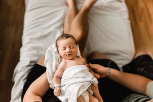 Fresh baby in Fort Wayne Indiana wearing hospital blanket during their Fresh 48 session with Tiffany Bergamino Photography