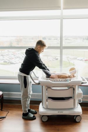 New big brother with brand new baby boy during Fresh 48 newborn hospital photographer in Marion Indiana